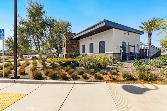 16502 Casa Grande Ave Unit 318, Fontana, CA 92336 - view of home's exterior featuring stone siding and stucco siding