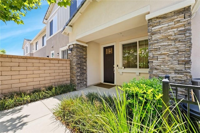 16502 Casa Grande Ave Unit 318, Fontana, CA 92336 - view of exterior entry with stone siding and stucco siding