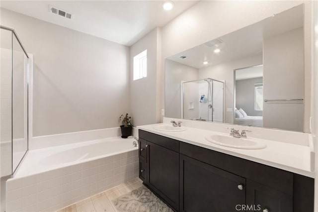 16502 Casa Grande Ave Unit 318, Fontana, CA 92336 - ensuite bathroom featuring a stall shower, a garden tub, and double vanity