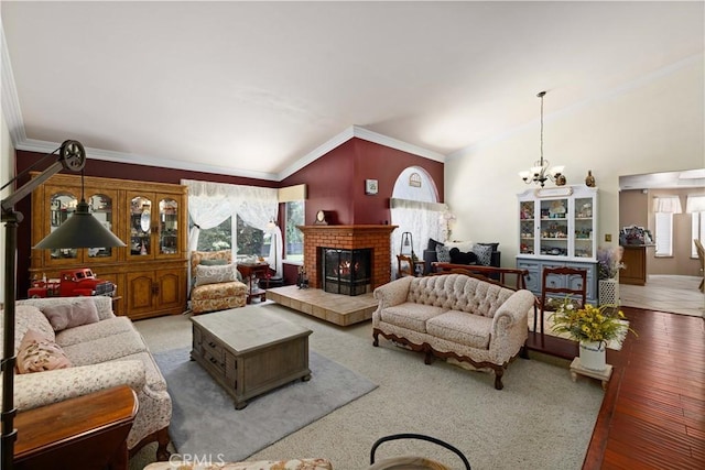 5647 Redwood Ave, Palmdale, CA 93551 - living area with a chandelier, a fireplace, crown molding, vaulted ceiling, and wood finished floors