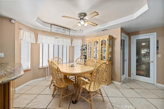 5647 Redwood Ave, Palmdale, CA 93551 - dining space with a tray ceiling, a ceiling fan, and light tile patterned floors