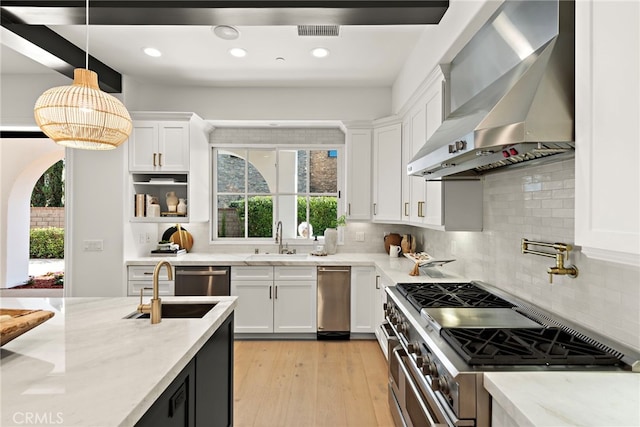 6 Rickie, Ladera Ranch, CA 92694 - kitchen with wall chimney range hood, stainless steel appliances, plenty of natural light, white cabinets, and recessed lighting