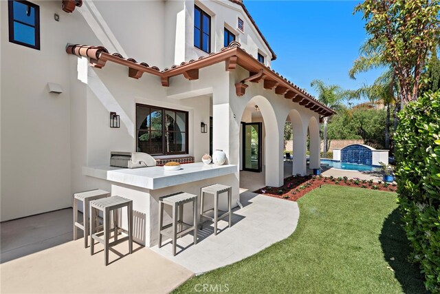 6 Rickie, Ladera Ranch, CA 92694 - rear view of property featuring stucco siding, an outdoor pool, area for grilling, and a patio