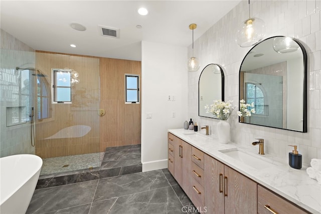 6 Rickie, Ladera Ranch, CA 92694 - full bath featuring double vanity, a freestanding tub, a walk in shower, marble finish flooring, and tile walls