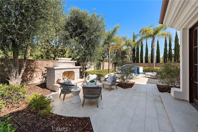 6 Rickie, Ladera Ranch, CA 92694 - fenced backyard featuring an outdoor stone fireplace and a patio area