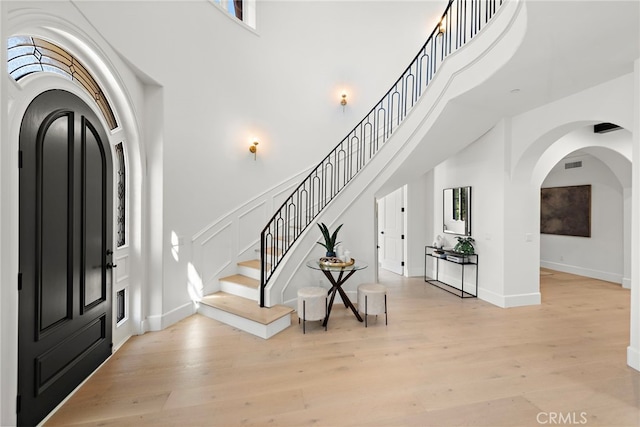 6 Rickie, Ladera Ranch, CA 92694 - foyer entrance with a high ceiling, arched walkways, light wood-style flooring, and stairway