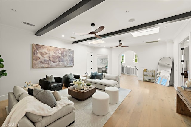 6 Rickie, Ladera Ranch, CA 92694 - living room with ceiling fan, beam ceiling, light wood-style floors, ornamental molding, and arched walkways