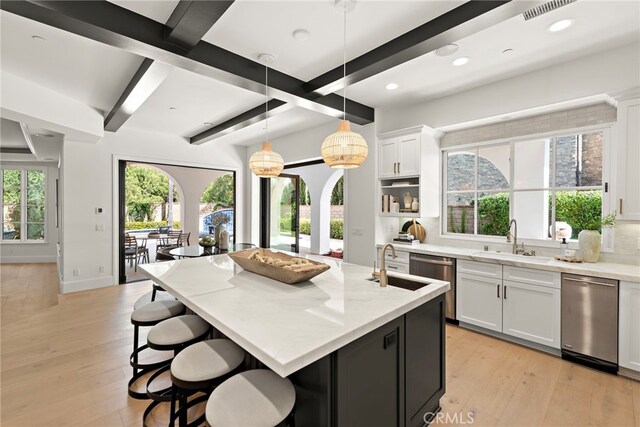 6 Rickie, Ladera Ranch, CA 92694 - kitchen with stainless steel dishwasher, white cabinets, light wood-style flooring, recessed lighting, and hanging light fixtures