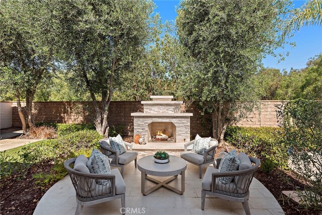 6 Rickie, Ladera Ranch, CA 92694 - fenced backyard with a patio and an outdoor living space with a fireplace