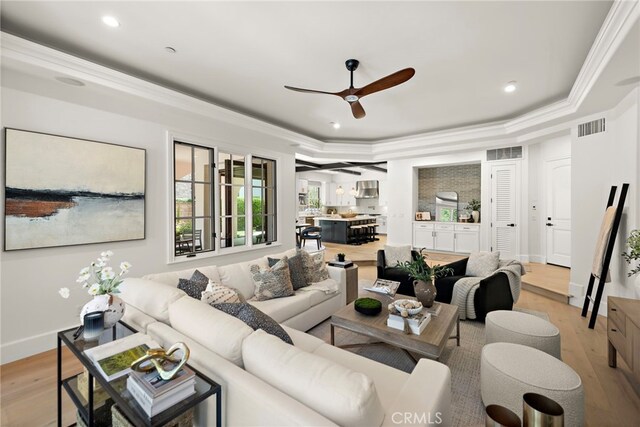 6 Rickie, Ladera Ranch, CA 92694 - living area with light wood-style floors, a ceiling fan, a raised ceiling, recessed lighting, and crown molding