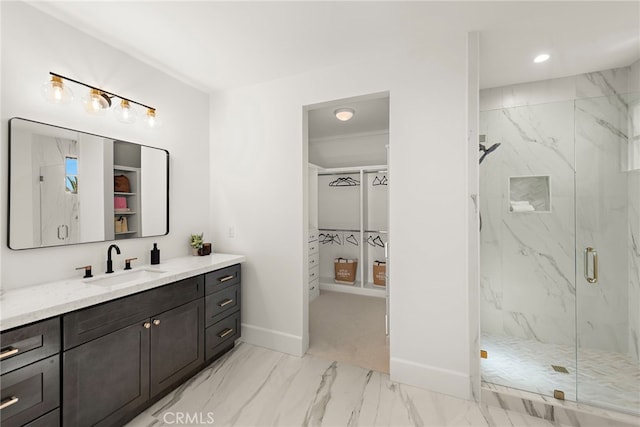 6 Rickie, Ladera Ranch, CA 92694 - bathroom with marble look tile flooring, a marble finish shower, vanity, a walk in closet, and recessed lighting