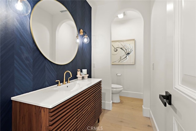 6 Rickie, Ladera Ranch, CA 92694 - bathroom featuring wood finished floors, vanity, and wallpapered walls