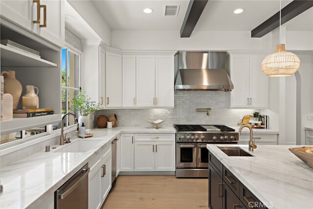 6 Rickie, Ladera Ranch, CA 92694 - kitchen with wall chimney exhaust hood, appliances with stainless steel finishes, beamed ceiling, white cabinets, and backsplash