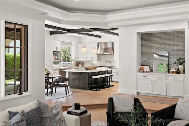 6 Rickie, Ladera Ranch, CA 92694 - living area with light wood-type flooring, ornamental molding, and beamed ceiling