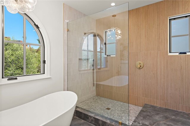 6 Rickie, Ladera Ranch, CA 92694 - bathroom with a soaking tub, a walk in shower, and a chandelier