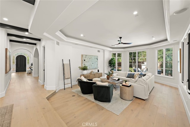 6 Rickie, Ladera Ranch, CA 92694 - living room with arched walkways, a raised ceiling, a ceiling fan, light wood-type flooring, and recessed lighting