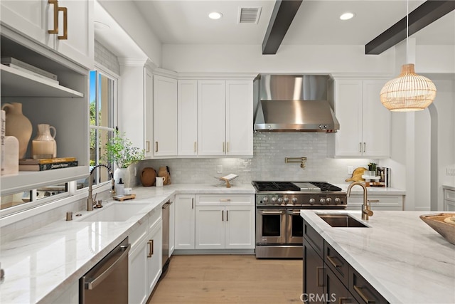 6 Rickie, Ladera Ranch, CA 92694 - kitchen featuring wall chimney range hood, appliances with stainless steel finishes, beam ceiling, white cabinets, and tasteful backsplash