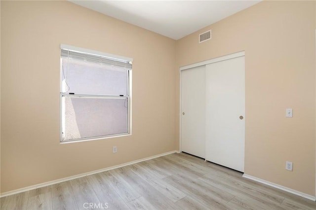 27861 Crown Court Cir Unit 72, Valencia, CA 91354 - unfurnished bedroom with wood finished floors, a closet, and multiple windows