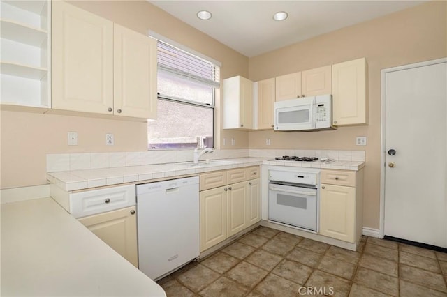27861 Crown Court Cir Unit 72, Valencia, CA 91354 - kitchen featuring white appliances, tile counters, recessed lighting, open shelves, and white cabinets