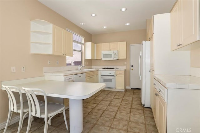 27861 Crown Court Cir Unit 72, Valencia, CA 91354 - kitchen featuring white appliances, a peninsula, light countertops, a breakfast bar area, and open shelves