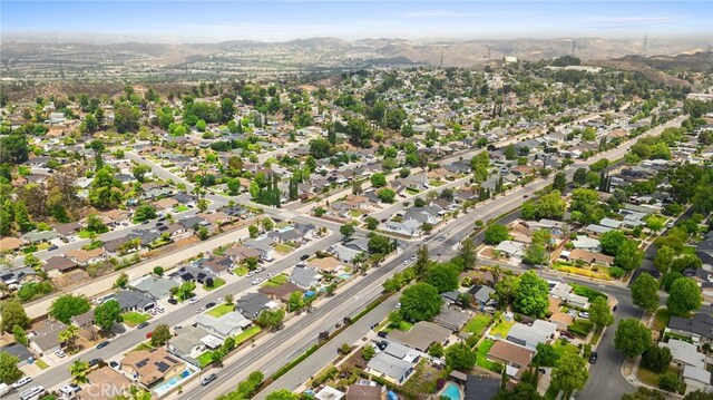 27439 Santa Clarita Rd, Saugus, CA 91350 - aerial overview of property's location with a mountain backdrop and nearby suburban area