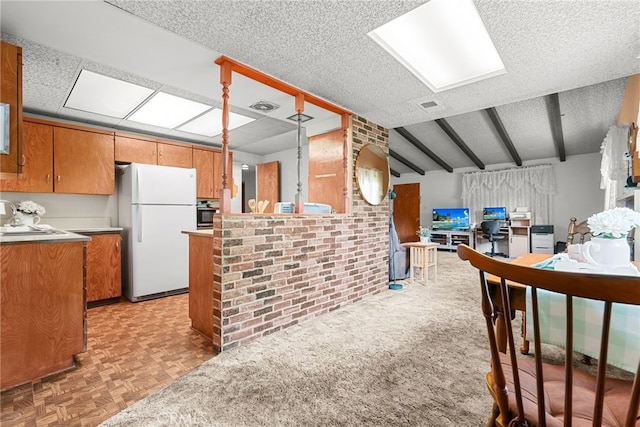 27439 Santa Clarita Rd, Saugus, CA 91350 - kitchen with freestanding refrigerator, brown cabinetry, light countertops, a textured ceiling, and open floor plan