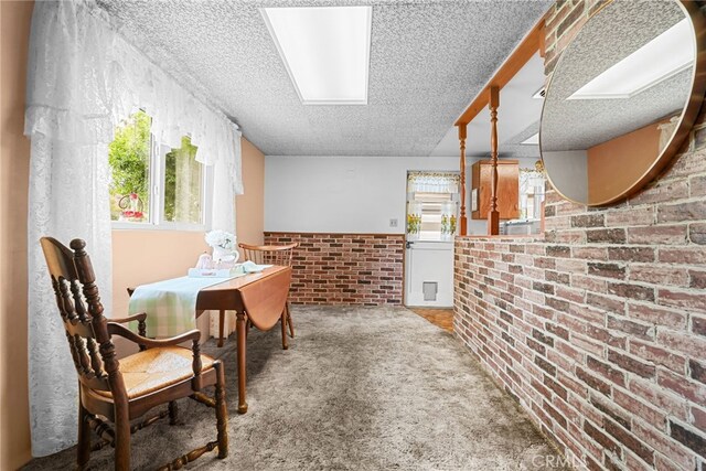 27439 Santa Clarita Rd, Saugus, CA 91350 - carpeted dining space featuring brick wall and a textured ceiling