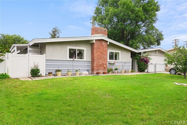 27439 Santa Clarita Rd, Saugus, CA 91350 - view of front facade with a chimney, a gate, and stucco siding