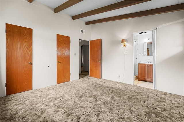 27439 Santa Clarita Rd, Saugus, CA 91350 - unfurnished bedroom featuring light carpet, beam ceiling, multiple closets, ensuite bathroom, and light tile patterned flooring