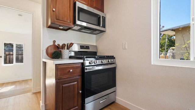 846 44th St, San Diego, CA 92102 - kitchen with stainless steel appliances, light wood-type flooring, and light countertops