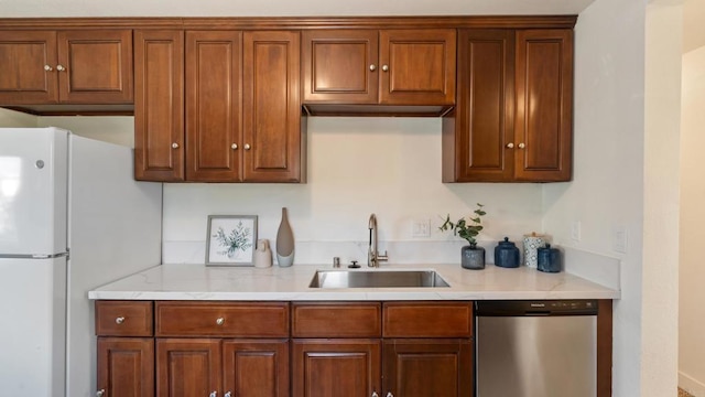 846 44th St, San Diego, CA 92102 - kitchen featuring stainless steel dishwasher, freestanding refrigerator, and brown cabinets