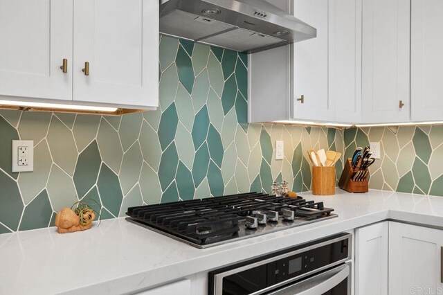 1488 Enchante, Oceanside, CA 92056 - kitchen featuring under cabinet range hood, stainless steel appliances, white cabinetry, and decorative backsplash
