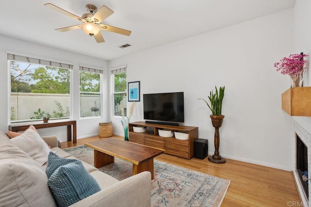1488 Enchante, Oceanside, CA 92056 - living area featuring wood finished floors, ceiling fan, and a fireplace