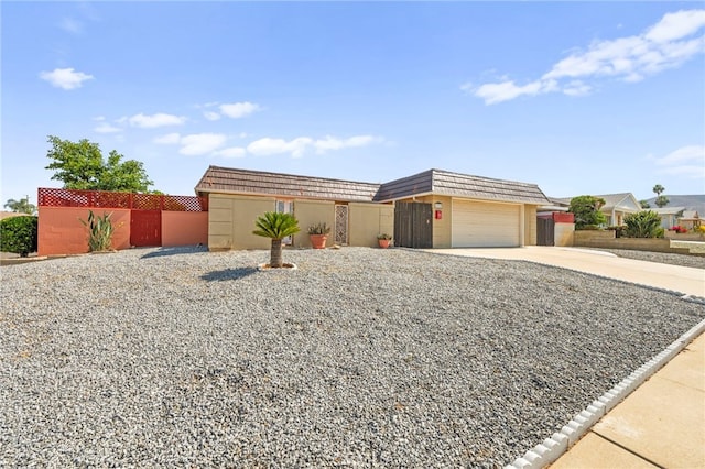 25925 Roanoke Rd, Menifee, CA 92586 - view of front facade featuring driveway, mansard roof, and an attached garage