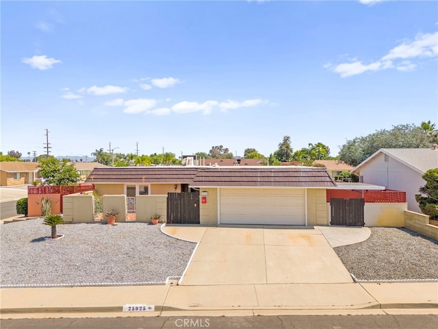 25925 Roanoke Rd, Menifee, CA 92586 - view of front of house featuring a garage, driveway, a tile roof, and a gate