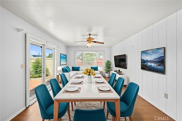 25925 Roanoke Rd, Menifee, CA 92586 - dining space featuring ceiling fan, wood finished floors, and wood walls