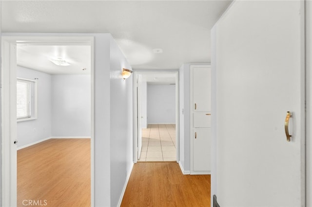25925 Roanoke Rd, Menifee, CA 92586 - hallway featuring light wood-style flooring and baseboards