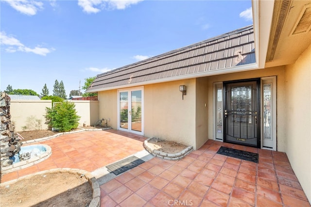 25925 Roanoke Rd, Menifee, CA 92586 - entrance to property with stucco siding, mansard roof, and a patio area