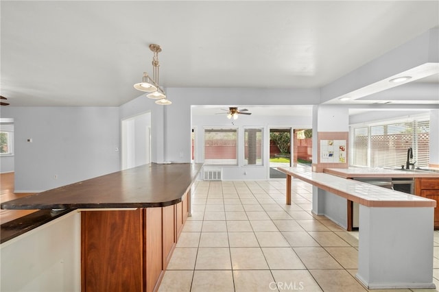 25925 Roanoke Rd, Menifee, CA 92586 - kitchen with a ceiling fan, open floor plan, light tile patterned floors, and dark countertops