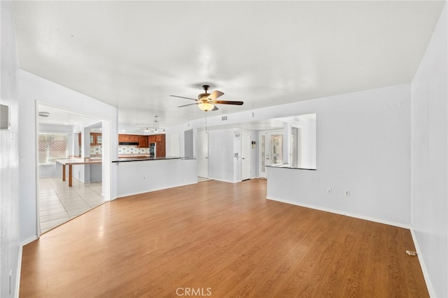 25925 Roanoke Rd, Menifee, CA 92586 - unfurnished living room featuring a ceiling fan and light wood-type flooring