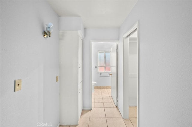 25925 Roanoke Rd, Menifee, CA 92586 - hall featuring light tile patterned flooring and baseboards