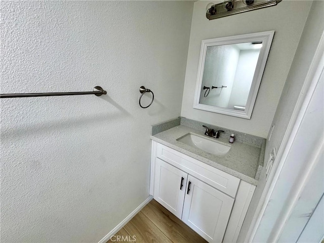 13105 Via Tuscany, Riverside, CA 92503 - bathroom with vanity, wood finished floors, and a textured wall
