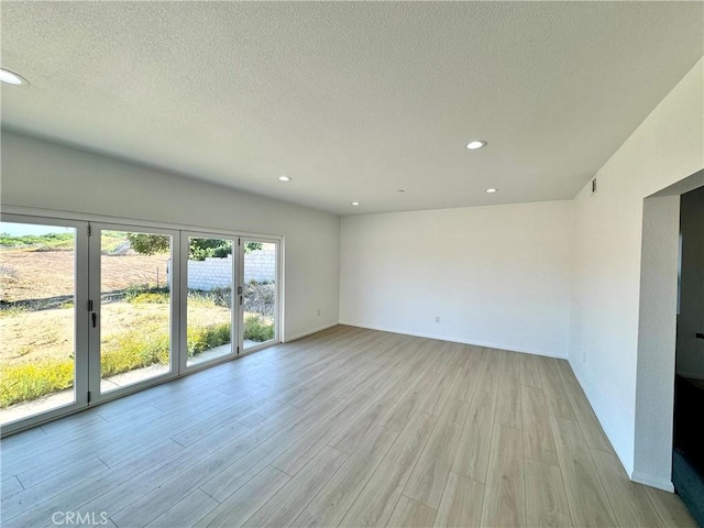 13105 Via Tuscany, Riverside, CA 92503 - empty room with recessed lighting, light wood finished floors, and a textured ceiling