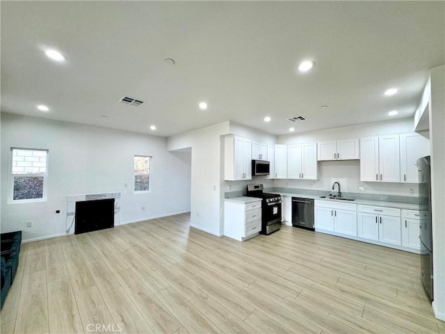 13105 Via Tuscany, Riverside, CA 92503 - kitchen featuring appliances with stainless steel finishes, open floor plan, light wood-style floors, recessed lighting, and white cabinetry
