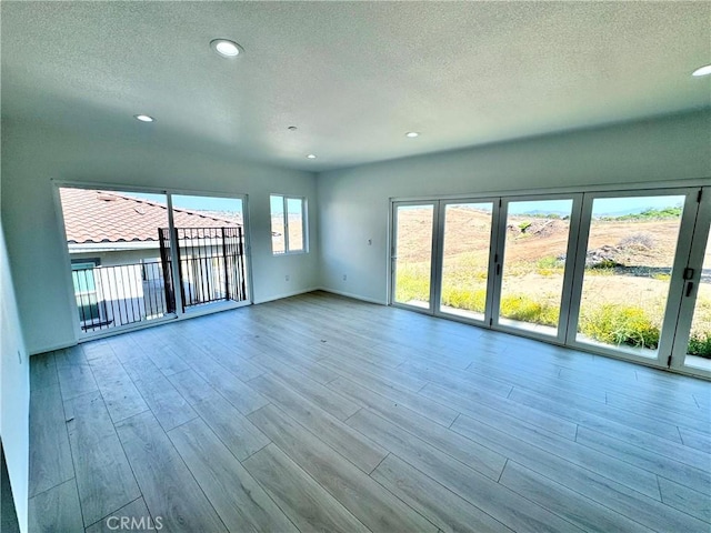 13105 Via Tuscany, Riverside, CA 92503 - empty room with a textured ceiling, wood finished floors, and recessed lighting