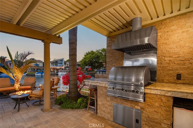 21891 Winnebago Ln, Lake Forest, CA 92630 - view of patio / terrace with an outdoor kitchen, a water view, and a fire pit