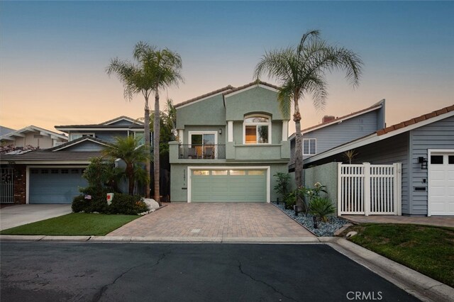 21891 Winnebago Ln, Lake Forest, CA 92630 - view of front of property with driveway, a balcony, and stucco siding
