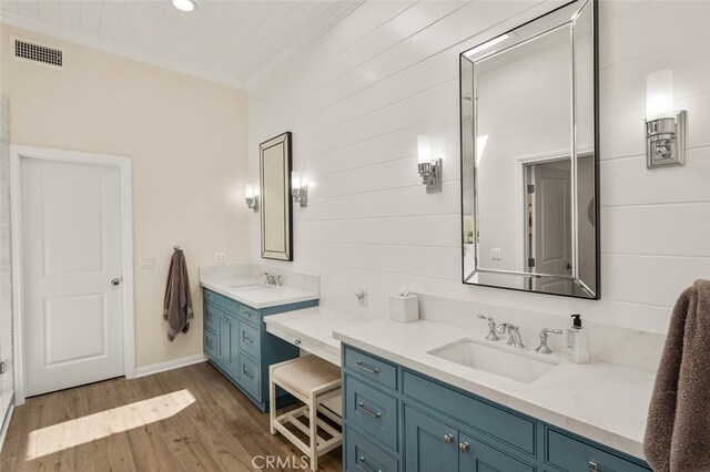 21891 Winnebago Ln, Lake Forest, CA 92630 - full bath featuring vanity, ornamental molding, wood finished floors, recessed lighting, and wood walls