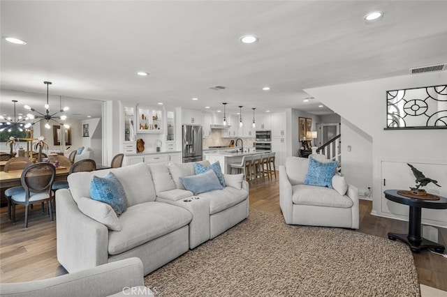 21891 Winnebago Ln, Lake Forest, CA 92630 - living area with wood finished floors, stairway, recessed lighting, and a chandelier