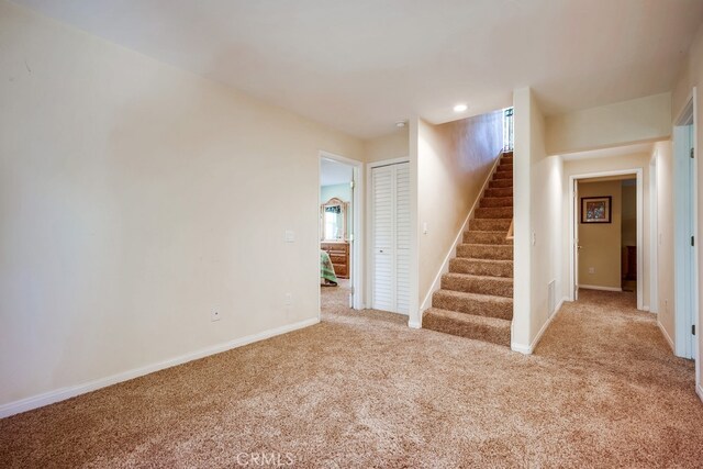 163 Wylerhorn Dr, Crestline, CA 92325 - unfurnished living room featuring carpet floors and stairway